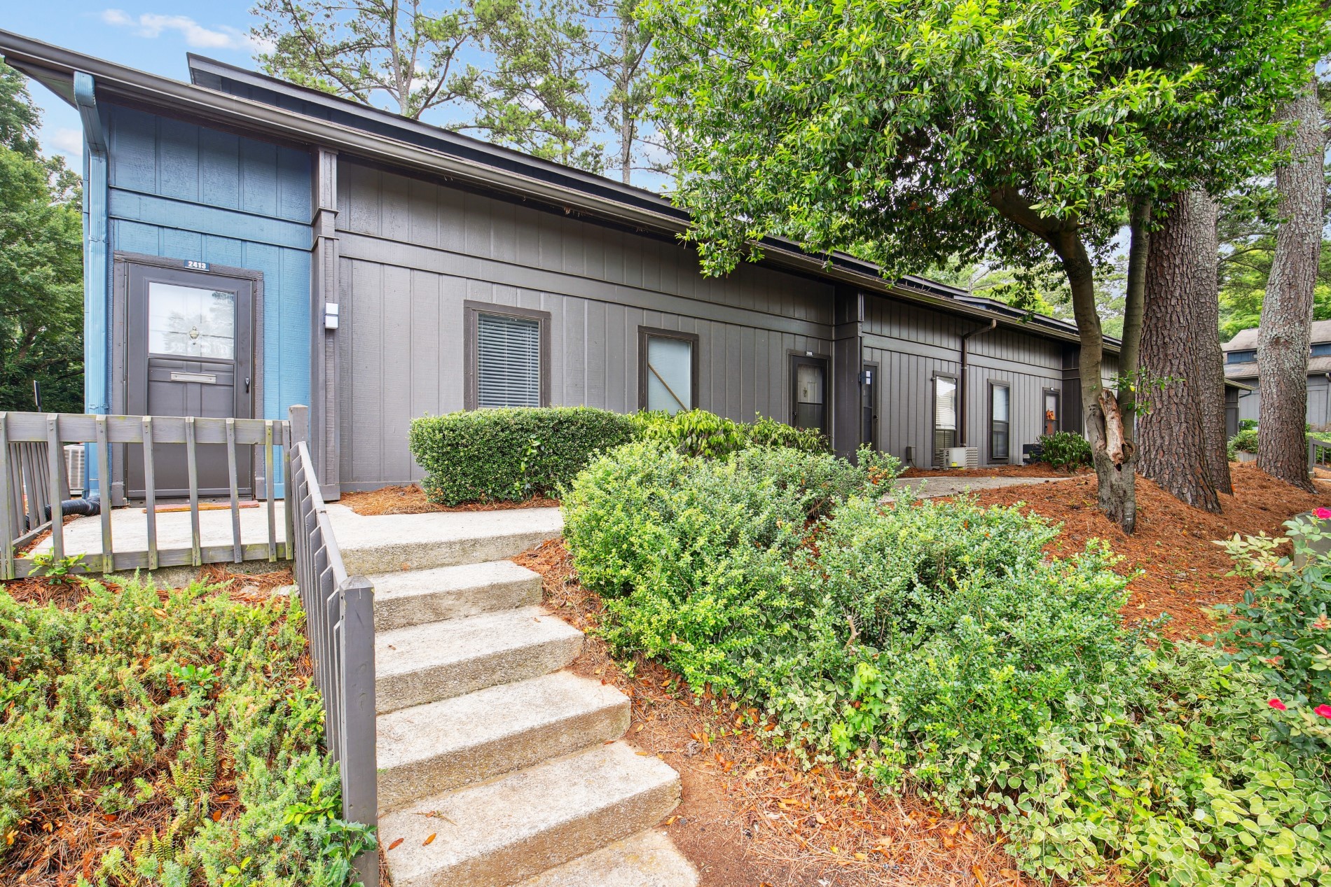 steps leading up to a gray house with blue walls